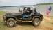 Jeep with flag up and over berm